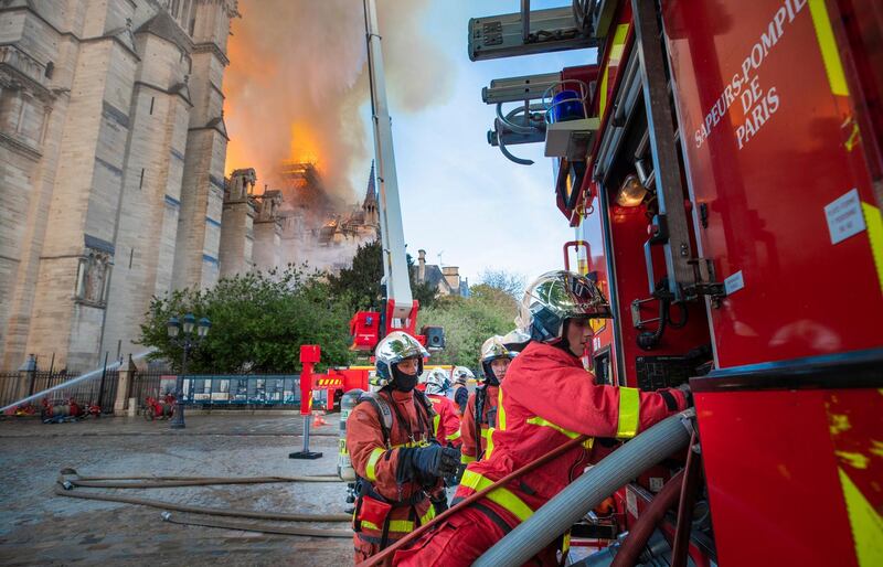 This photo provided Tuesday April 16, 2019 by the Paris Fire Brigade, shows fire fighters working at the burning Notre Dame cathedral, Monday April 15, 2019. Experts assessed the blackened shell of Paris' iconic Notre Dame Tuesday morning to establish next steps to save what remains after a devastating fire destroyed much of the cathedral that had survived almost 900 years of history. (Benoit Moser, BSPP via AP)