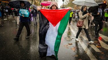 A woman holds a Palestinian flag during a rally, in Paris, on November 18, 2023. AP Photo
