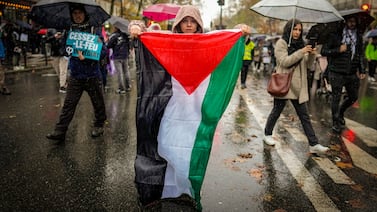 A woman holds a Palestinian flag during a rally, in Paris, on November 18, 2023. AP Photo