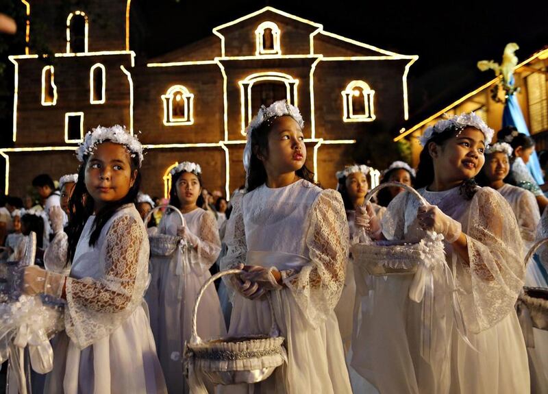 Filipino children participate in a procession before a mass to mark Easter Sunday outside a church in Las Pinas City, south of Manila, Philippines. Francis R Malasig / EPA
