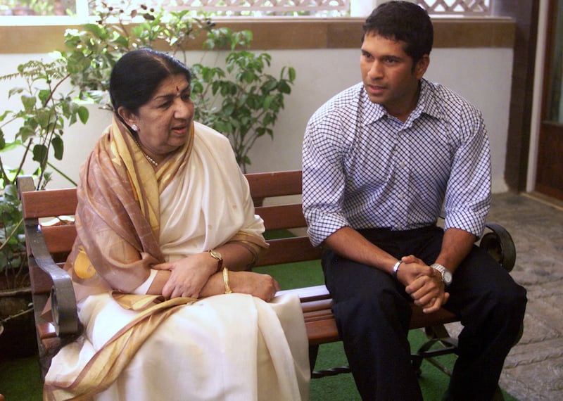 Lata Mangeshkar, left, speaks with cricket great Sachin Tendulkar about an upcoming charity cricket match, during a meeting in Bombay on March 28, 2003. India and Sri Lanka will play a day-night cricket match as part of a fund-raising effort for a cancer hospital sponsored by the Mangeshkar family in Pune. AFP