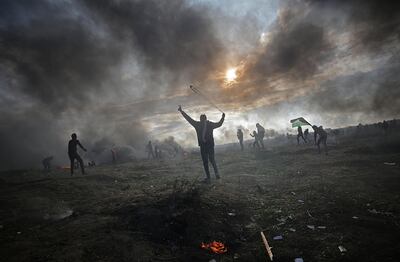 epa06392203 Palestinian protesters throw stones at Israeli troops during clashes near the border with Israel, against US President decision to recognize Jerusalem as the capital of Israel, in the east of Gaza City, 15 December 2017. Two Palestinians were killed during the clashes in the east of Gaza Strip. US president Donald J. Trump on 06 December announced he is recognizing Jerusalem as the Israel capital and will relocate the US embassy from Tel Aviv to Jerusalem.  EPA/MOHAMMED SABER