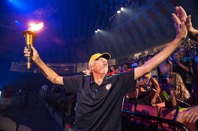 Dick Fosbury greets fans while carrying the torch to kick off the Commonwealth Games in July 2016. AP