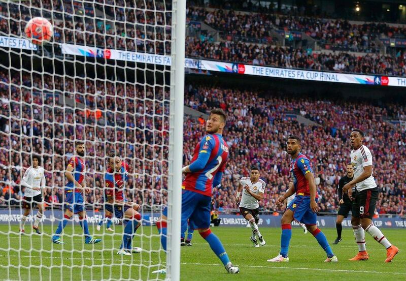 Manchester United’s English midfielder Jesse Lingard (4th L) turns to celebrate after scoring their second goal in extra time during the English FA Cup final football match between Crystal Palace and Manchester United at Wembley stadium in London on May 21, 2016. Ian Kington / AFP