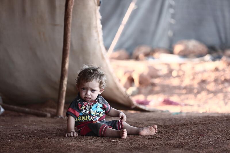 A Syrian child is pictured at a refugee camp in Al Ghadfa, southeast of Idlib province. AFP