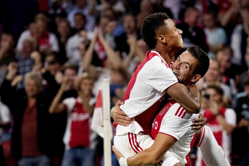 epa06950136 David Neres (L) of Ajax celebrates with teammate Dusan Tadic (R) scoring the 3-0 goal during the Champions League third qualifying round match between Ajax Amsterdam and Standard Liege in Amsterdam, The Netherlands, 14 August 2018.  EPA/OLAF KRAAK