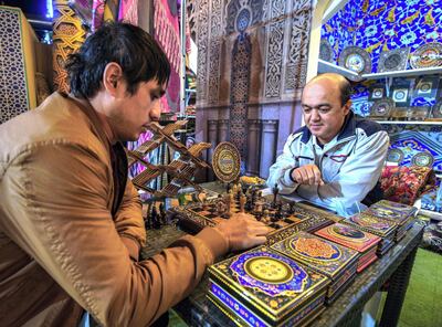 Abu Dhabi, United Arab Emirates, January 10, 2021. Kamaliddin Abdullaev plays chess on a wooden hand made chess board from Uzbekistan at  the Sheikh Zayed Festival.
Victor Besa/The National
Section:  NA
Reporter:  Saeed Saeed
