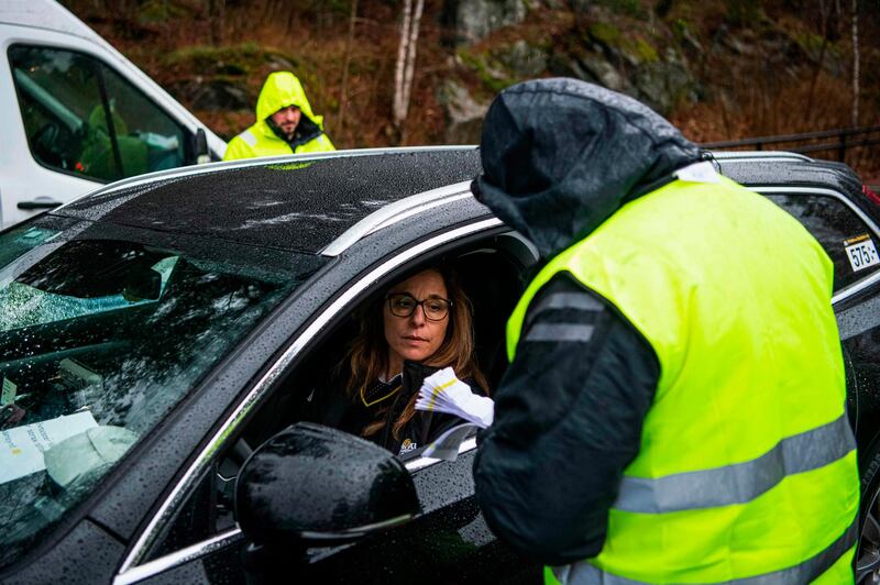 Jotta Nikopoulou, 45, a driver with the company Taxi Stockholm, returns PCR tests for processing after collecting them from people who suspect they have Covid-19, in a suburb of Stockholm, Sweden. AFP