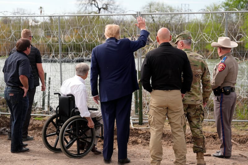 Former US president and Republican candidate Donald Trump waves to people across the Rio Grande in Mexico at Shelby Park in Eagle Pass, Texas, during a visit to the border. AP