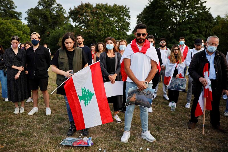 Lebanese come together for a vigil held at Kensington gardens in central London to honour the victims of the Beirut blast. AFP