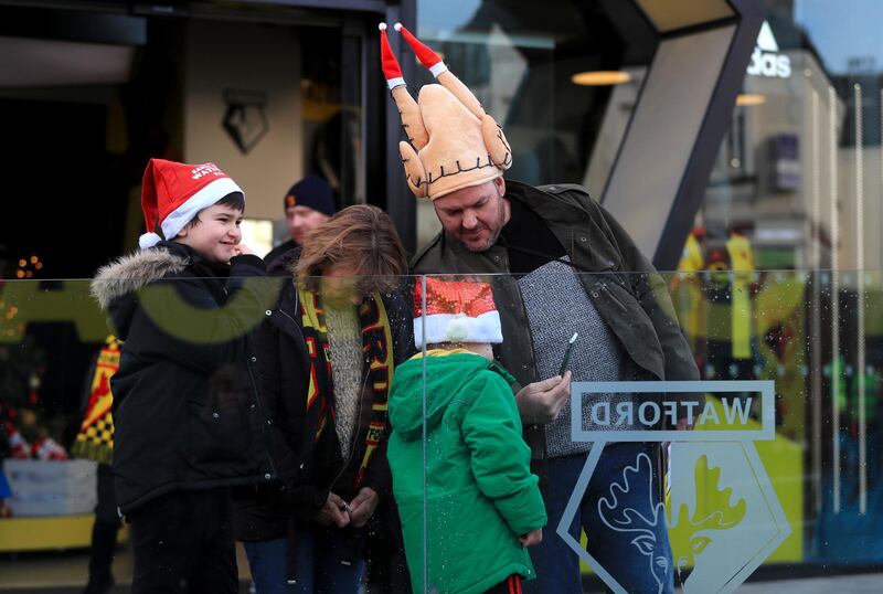 Watford fans wearing christmas hats arrive ahead of the Premier League match at Vicarage Road, Watford. PA Photo