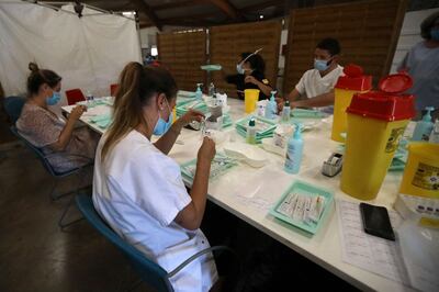 Health workers prepare syringes containing a dose of a Covid-19 vaccine at a vaccination centre in Perpignan, southern France. AFP