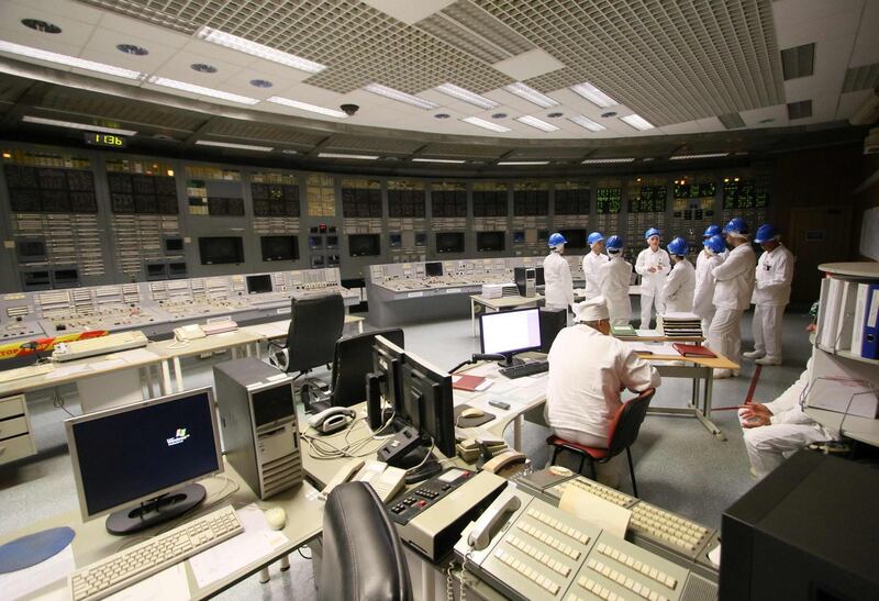 People stand in the monitoring room during a guided tour inside the inoperative Ignalina nuclear power plant.