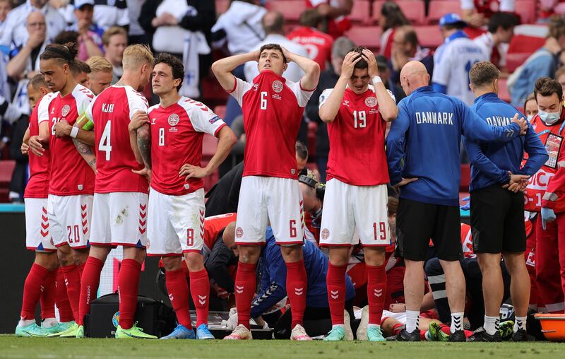 Distraught Denmark players look away while their teammate Christian Eriksen receives medical treatment after collapsing during the Euro 2020 match against Finland in Copenhagen on June 12.