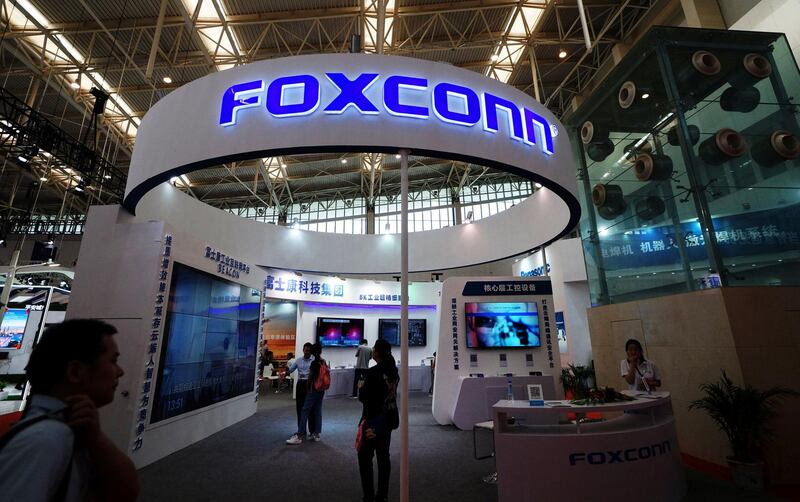 Visitors are seen at a Foxconn booth at the World Intelligence Congress in Tianjin, China May 19, 2018. Picture taken May 19, 2018. REUTERS/Stringer  ATTENTION EDITORS - THIS IMAGE WAS PROVIDED BY A THIRD PARTY. CHINA OUT.