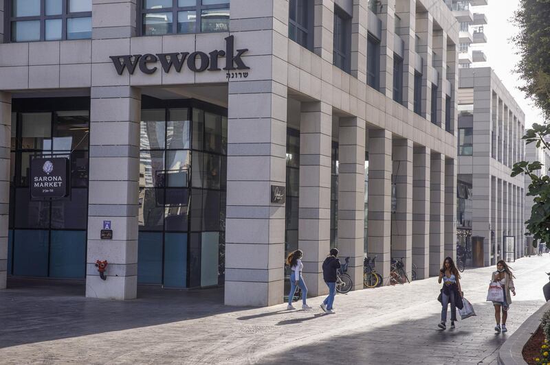 Pedestrians walk by a WeWork co-working office in Tel Aviv, Israel, on Thursday April 29, 2021. With commercial activity heating up in Tel Aviv, employers and employees around the world are watching with interest to see what happens in a country that has come to be seen as a late-pandemic bellwether. Photographer: Kobi Wolf/Bloomberg