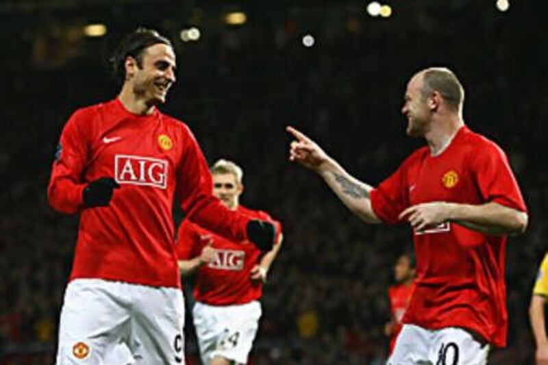 MANCHESTER, UNITED KINGDOM - OCTOBER 21:  Dimitar Berbatov (L) of Manchester United celebrates his second goal with team mate Wayne Rooney during the UEFA Champions League Group E match between Manchester United and Celtic at Old Trafford on October 21, 2008 in Manchester, England.  (Photo by Alex Livesey/Getty Images) *** Local Caption ***  GYI0056007003.jpg