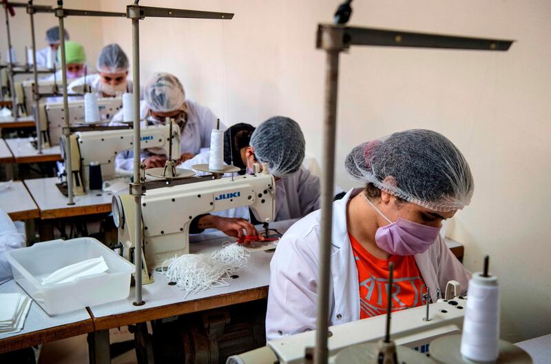 Mask-clad inmates produce protective masks at the Oukacha prison in Casablanca.   AFP