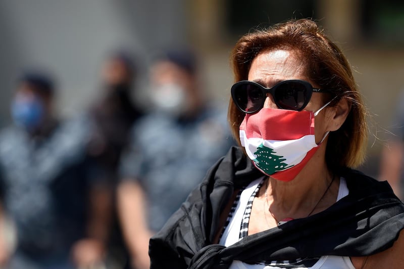 epa08416380 An Anti-government protester, wearing a mask, takes part in a protest near the French embassy in Beirut, Lebanon, 12 May 2020. Protest called for French authorities to cancel financially help, via the CEDRE program, to what protestors called the corrupt Lebanon government.  EPA/WAEL HAMZEH