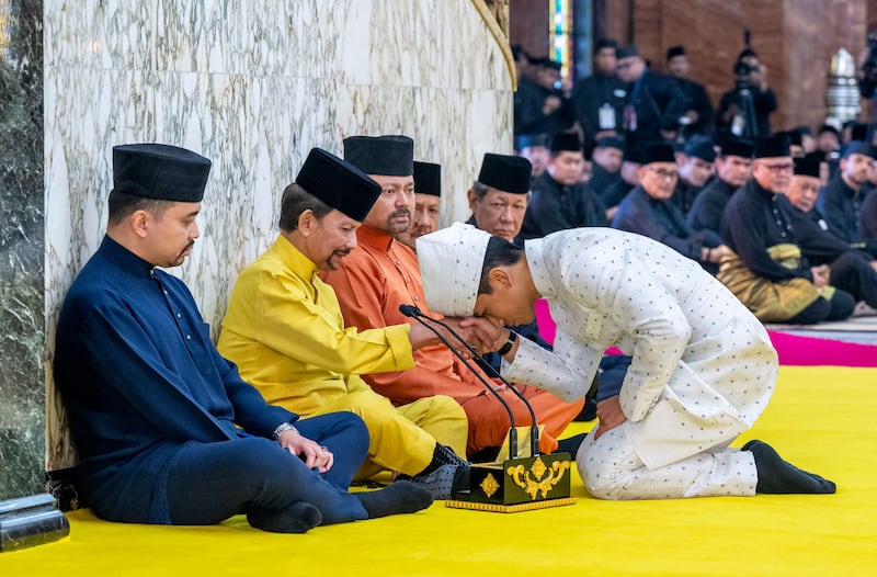 Brunei's Prince Abdul MateeN touching his forehead on his father's hand, Brunei's Sultan Haji Hassanal Bolkiah after his solemnisation at Sultan Omar Ali Saifuddien Mosque in Bandar Seri Begawan. Photo: Brunei's Information Department