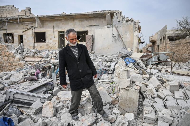 Malek Haj Khalil stands on the rubble of his home in Sarmin, about 8 kilometres south-east of Idlib city. AFP