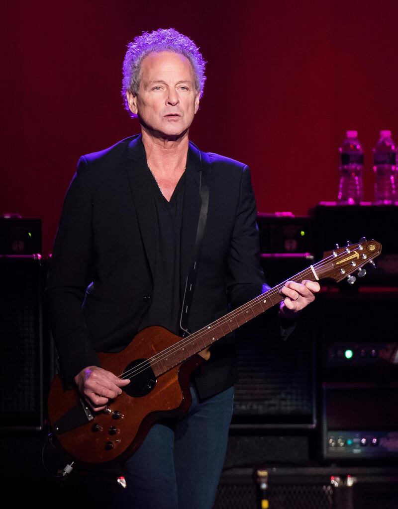 FILE - In this Oct. 6, 2014 file photo, Lindsey Buckingham from the band Fleetwood Mac performs at Madison Square Garden in New York. The band said in a statement Monday that Buckingham is out of the band for its upcoming tour. Buckingham left the group once before, from 1987 to 1996.  Heâ€™ll be jointly replaced by Neil Finn of Crowded House and Mike Campbell of Tom Petty and the Heartbreakers.  (Photo by Charles Sykes/Invision/AP, FIle)