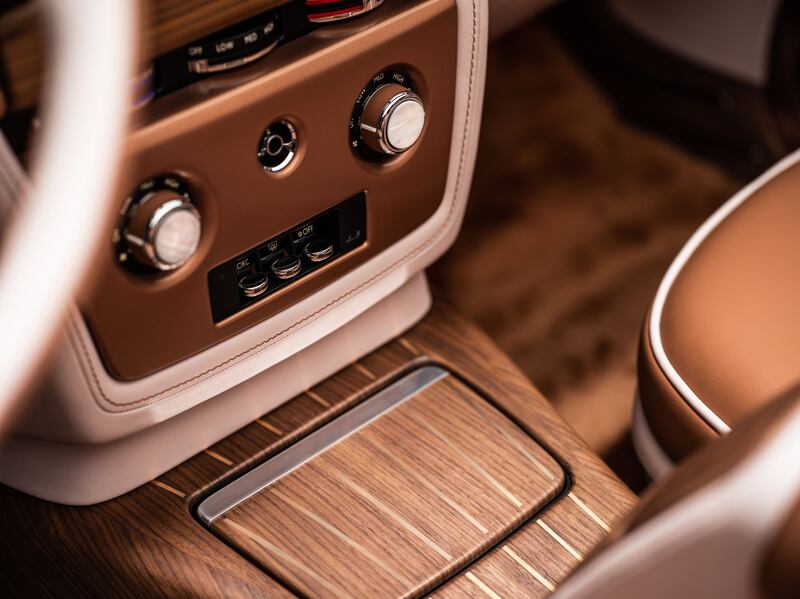 The wood-veneer interior is matched with earth-tone accents.