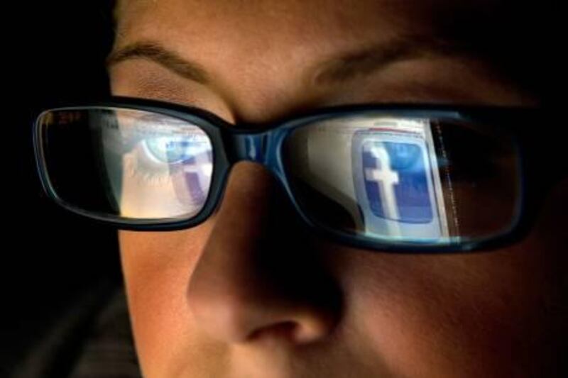 FILE: In this file photo the Facebook Inc. logo is reflected in the eyeglasses of a user in this arranged photo in San Francisco, California, U.S., on Wednesday, Dec. 7, 2011. A Facebook IPO would provide funds to help the social-networking service maintain its expansion and fend off competition from Internet rivals such as Google Inc. and Twitter Inc. Photographer: David Paul Morris/Bloomberg