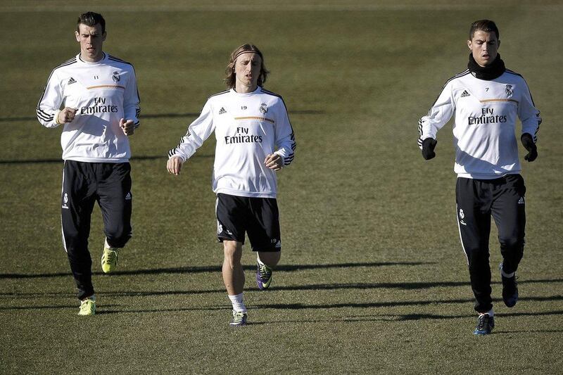 Cristiano Ronaldo, right, trains with Real Madrid teammates Luka Modric, centre, and Gareth Bale, left, on Friday. Emilio Naranjo / EPA