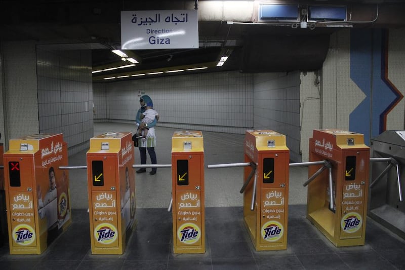 A woman carries her child at Al Shohadaa (Martyrs) metro station.