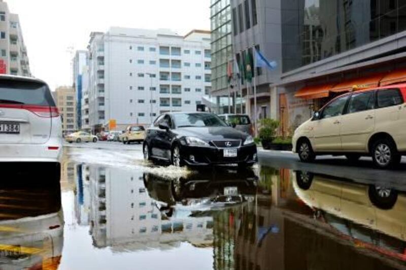 March 26. Motorcars drive through a big rain puddle left by overnight rain in Al Barsha. March 26. Dubai, United Arab Emirates (Photo: Antonie Robertson/The National)