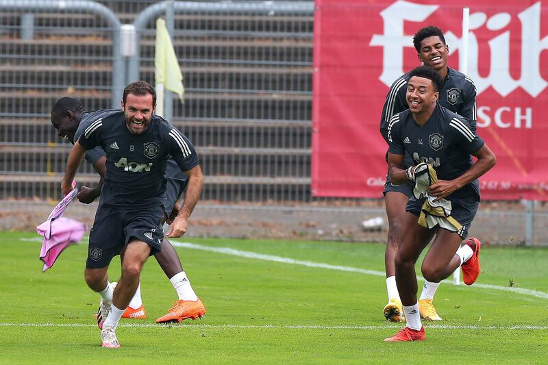 COLOGNE, GERMANY - AUGUST 15:  (L-R)  Juan Mata, Jesse Lingard and Marcus Rashford of Manchester United laugh during a training session at RheinEnergieStadion on August 15, 2020 in Cologne, Germany. (Photo by Matthew Peters/Manchester United via Getty Images)
