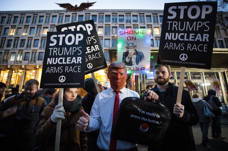 Protesters, one wearing a Donald Trump mask, demonstrate against the president outside the embassy in Grosvenor Square in 2017. Getty Images
