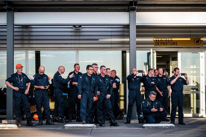 Members of a Dutch search and rescue team look on before boarding at Eindhoven Air Base.  AFP
