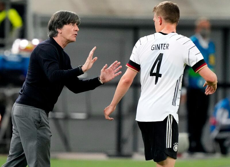 Germany's head coach Joachim Low, left, talks to Matthias Ginter on Monday. AP