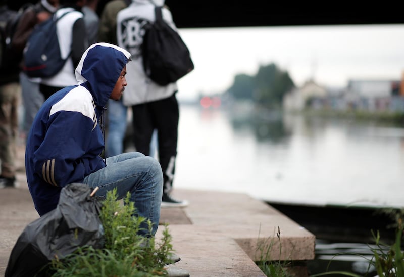 Migrants gather by the canal as French police evacuate hundreds of migrants living in makeshift camps in Paris, France. Benoit Tessier / Reuters