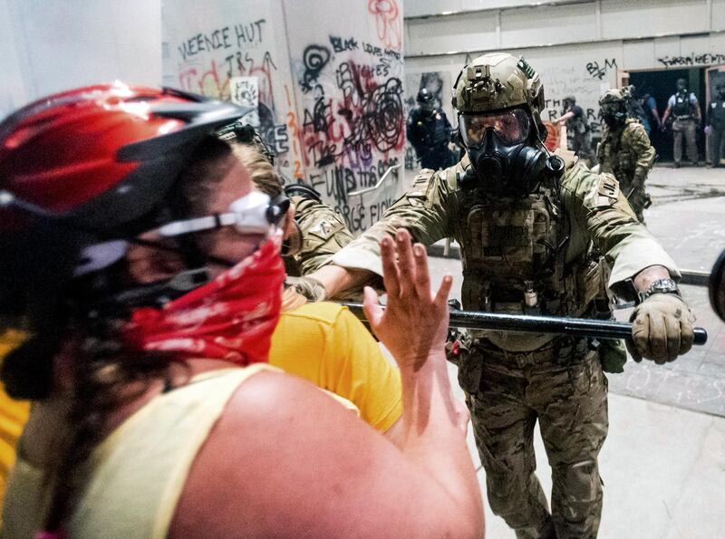 Federal officers disperse Black Lives Matter protesters in Portland. AP