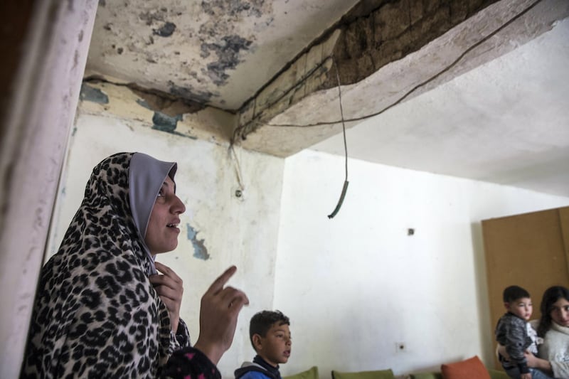 Palestinian mother of 6 Nisreen Awada,35, inside  her crumbling concrete home in Wadi Hilweh in Silwan, a contested neighborhood right beyond the Old CityÕs walls Of Jerusalem . 

AwadaÕs home, which she moved to when she married at 17, was long in need of renovations she couldnÕt afford. Except now the ceiling is falling and there are cracks in the wall outside. Her neighborsÕ houses display similar damage. Below AwadaÕs home, Israeli archeologists, backed by a right-wing nationalist Jewish organization, are digging a tunnel that they say traces a road Jewish worshippers used 2,000 years ago and now is set to be part of a larger tourist and religious attraction. 
(Photo by Heidi Levine for The National).