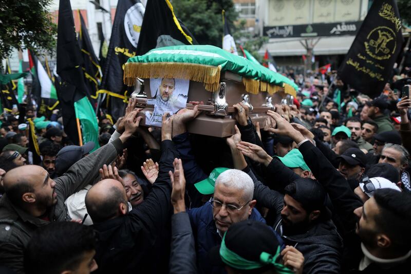 The coffin of Hamas deputy political leader Saleh Al Arouri is carried along a street as supporters gathered for his funeral in Beirut, Lebanon. Getty Images