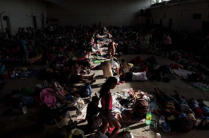 Migrant women and children rest at the City Hall, improvised as shelter, in Santiago Niltepec, Oaxaca state, Mexico. AFP