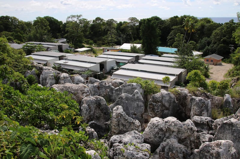 This photograph taken on September 2, 2018 shows a general view of refugee Camp Four on the Pacific island of Nauru. - A cluster of corrugated iron huts resembling military barracks jut out of Nauru's sweltering rocky landscape to reveal refugee settlement camp number five, a place defined by desperation and rarely visited by outsiders. (Photo by Mike LEYRAL / AFP)