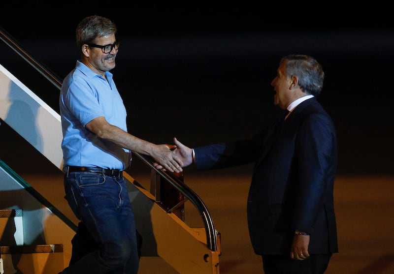 Italy's Foreign Minister Antonio Tajani greets the country's ambassador to Sudan, Michele Tommasi, as he arrives at Ciampino Airport. Reuters