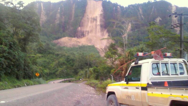 Locals inspect a landslide and damage to a road located near the township of Tabubil after an earthquake that struck Papua New Guinea's Southern Highlands, on February 26, 2018. Jerome Kay / Handout via Reuters