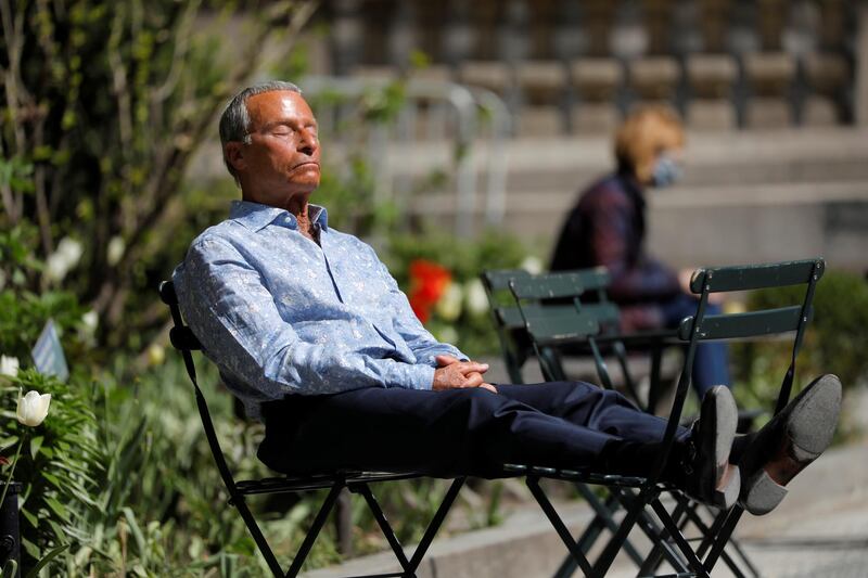 A person sits in Bryant Park after the Centers for Disease Control and Prevention (CDC) announced new guidelines regarding outdoor mask wearing and vaccination during the outbreak of the coronavirus disease (COVID-19) in Manhattan, New York City, New York, U.S., April 27, 2021. REUTERS/Andrew Kelly
