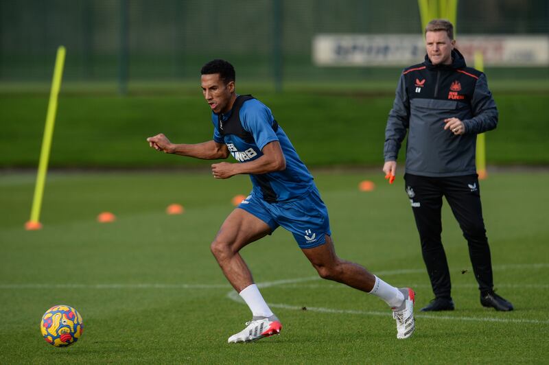 Isaac Hayden on the ball as Eddie Howe watches on his first training session.
