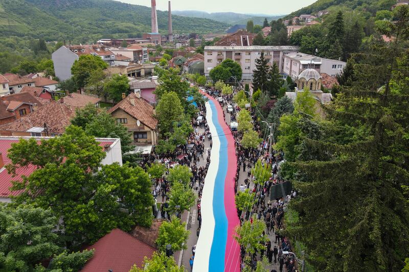 People hold a giant Serbian flag during a protest in the town of Zvecan in northern Kosovo. AP Photo