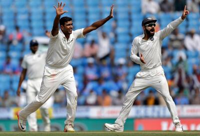 India's captain Virat Kohli, right, and Ravichandran Ashwin appeal unsuccessfully for the dismissal of Sri Lankan batsman during the first day of their second test cricket match in Nagpur, India, Friday, Nov. 24, 2017. (AP Photo/Rajanish Kakade)