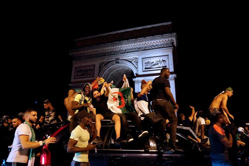 Algeria's supporters celebrate in front of the Arc de Triomphe on the Champs Elysee Avenue in Paris. AFP