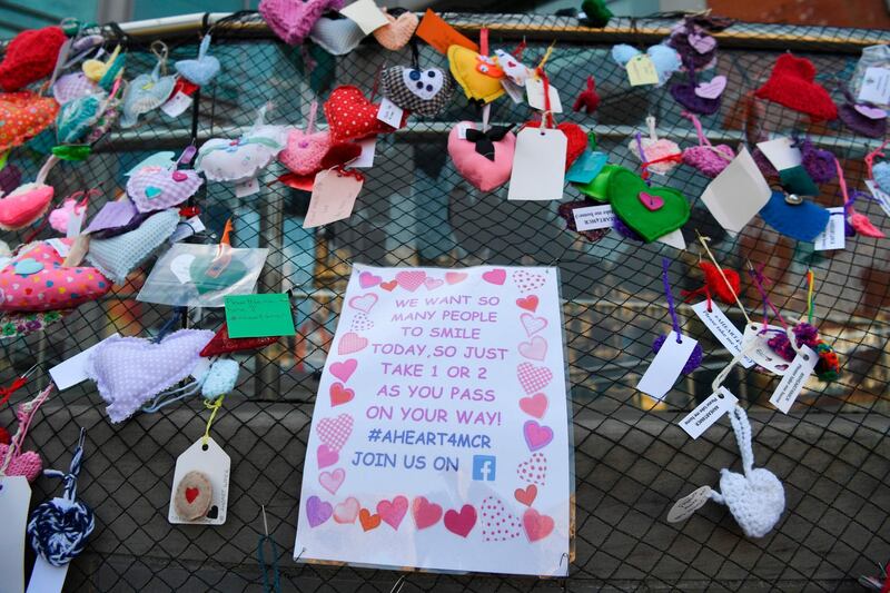 A fence is covered in hearts, offerings as a memorial following the Manchester Arena bombing, in central Manchester on May 22, 2018, the one year anniversary of the deadly attack. AFP