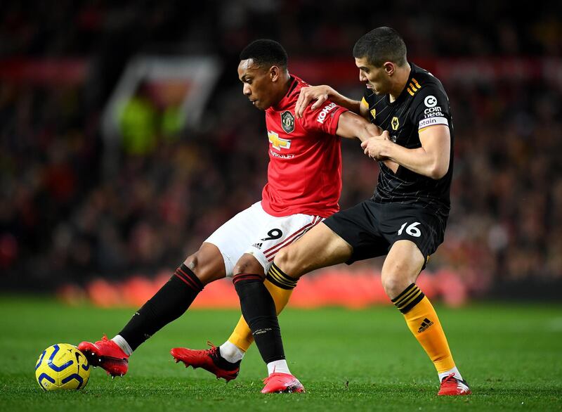 Anthony Martial of Manchester United, left, holds off a challenge from Conor Coady of Wolverhampton Wanderers. Getty
